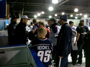 Luc signing autographs for some kids