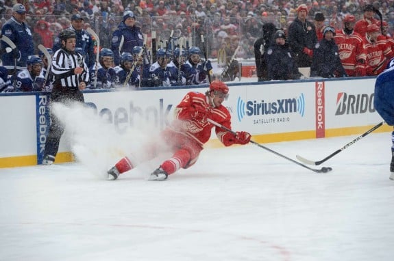A Red Wing stops hard on his skates creating a snow flurry (Tom Turk/The Hockey Writers)