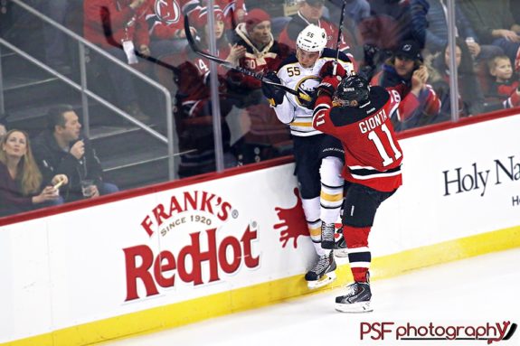 Stephen Gionta checks Rasmus Ristolainen into the boards. (Paula Faerman Photography/paulafaermanphotography.org)