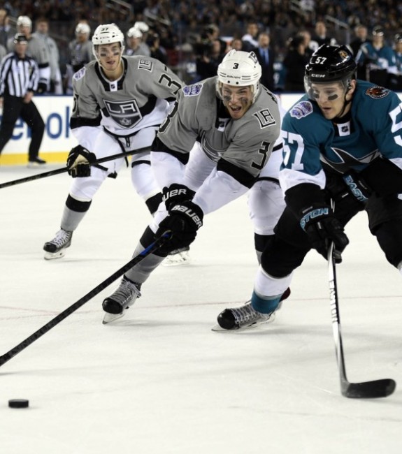 Brayden McNabb and Tommy Wingels skate for the puck in the Stadium Series (Kyle Terada-USA TODAY Sports)