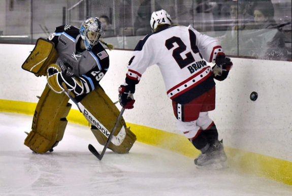 Brianne McLaughlin of the Buffalo Beauts plays the puck past Celeste Brown of the New York Riveters. (Photo Credit: Troy Parla)