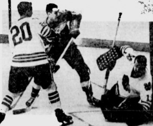 Red Wings Floyd Smith watches as team mate Ab Mcdonald's shot eludes Hawks goalie Glenn Hall.