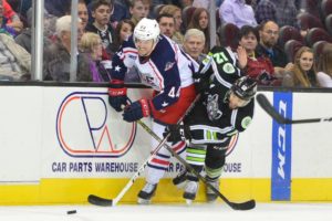 Brett Gallant battles hard along the boards to create a play. photo credit : John Saraya